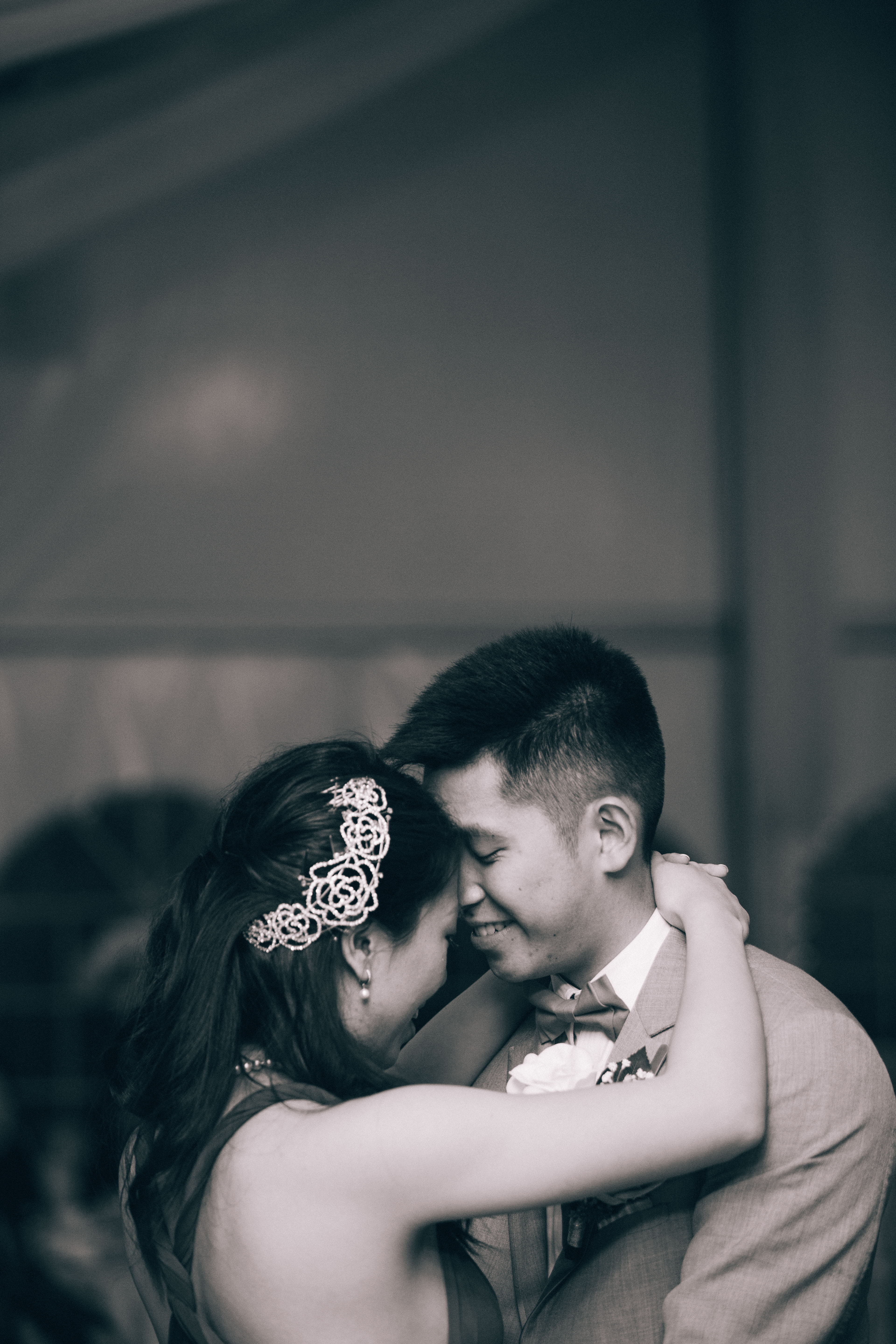Chinese bride and groom sharing a tender moment while dancing first dance at wedding reception at the Mandarin Country Club