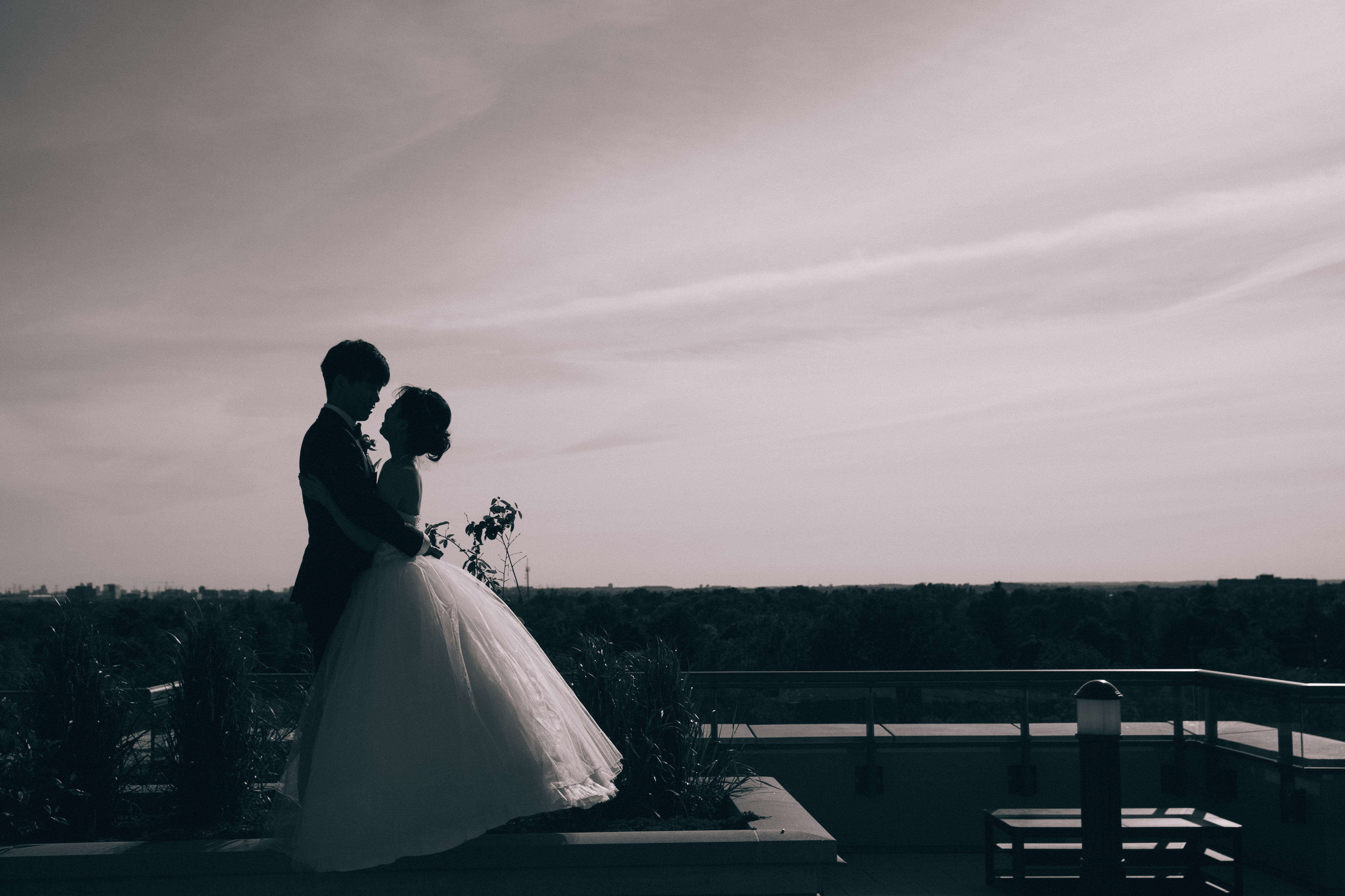 Silhouette of groom holding bride in a princess ball gown during their Christian summer wedding in Markham